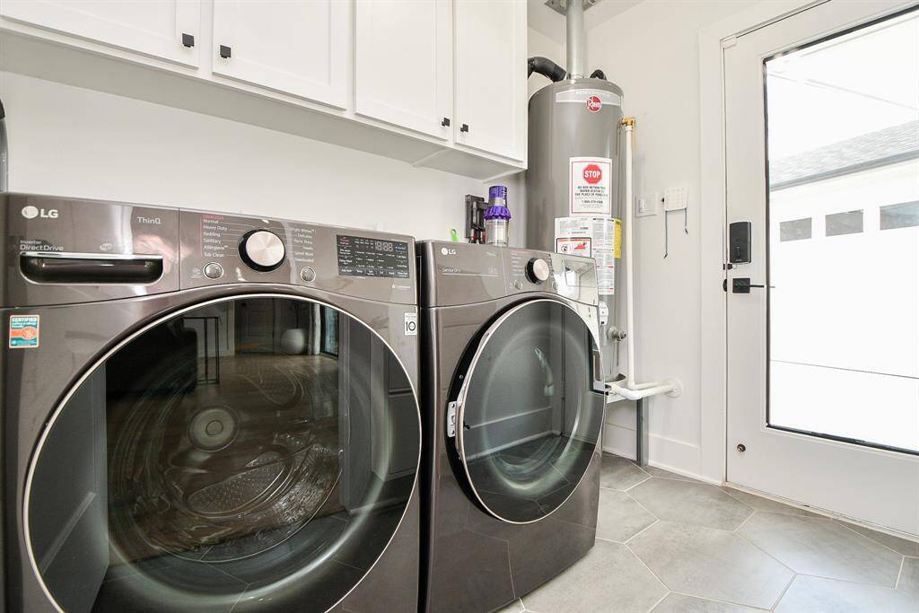 Efficient utility room featuring modern appliances, ample storage, and convenient outdoor access.