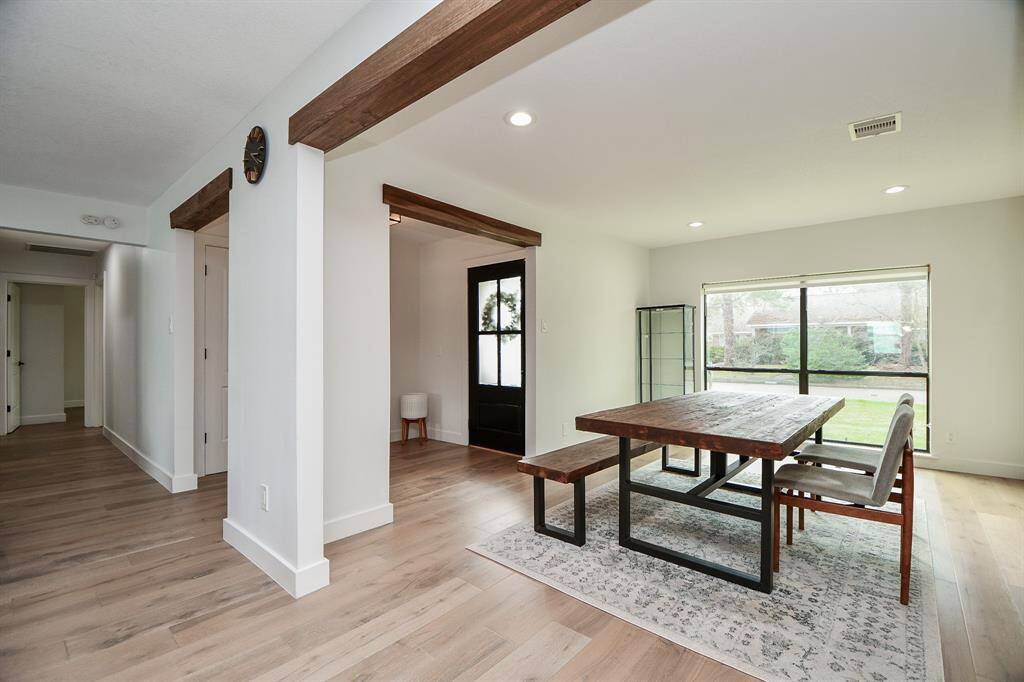 Elegant dining area with ample natural light and stylish wood accents.