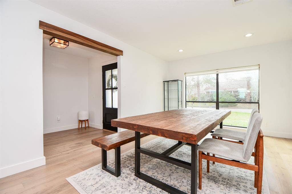 Elegant dining space with abundant natural light and modern finishes, perfect for entertaining.
