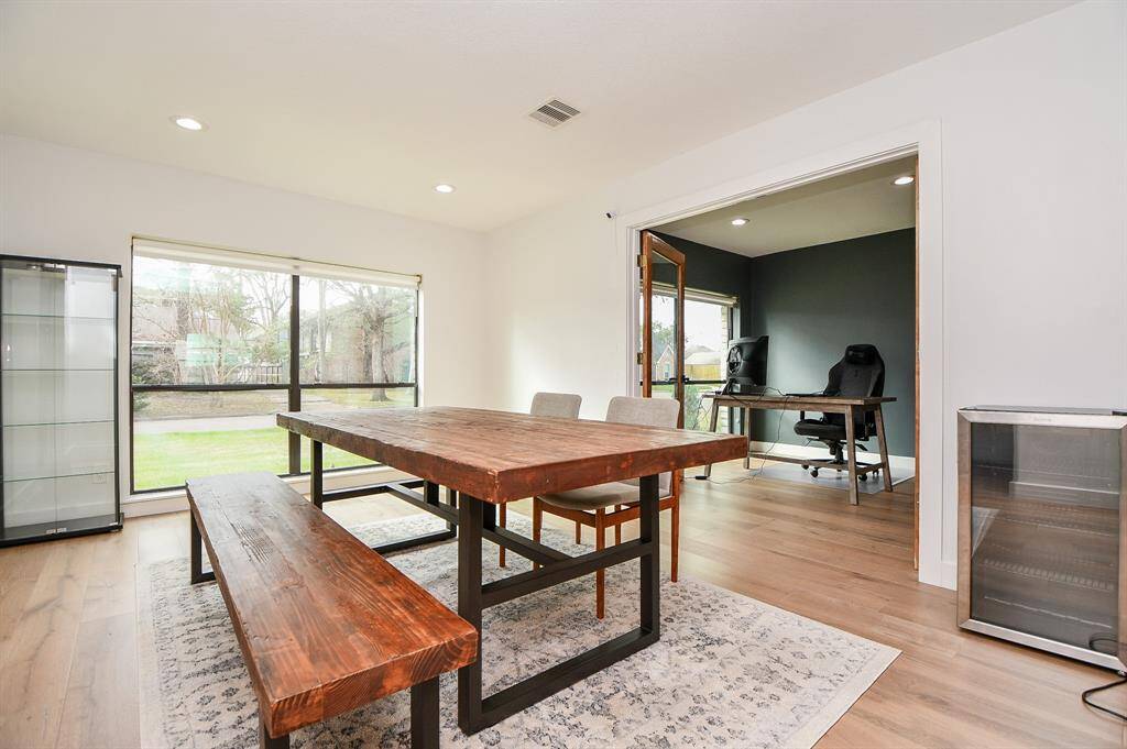 This inviting dining area features abundant natural light, elegant hardwood floors, and ample space for memorable gatherings.