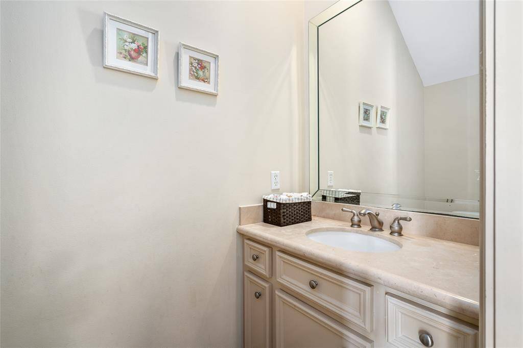 The powder rooms sits under the stairs, across from the dedicated office space.