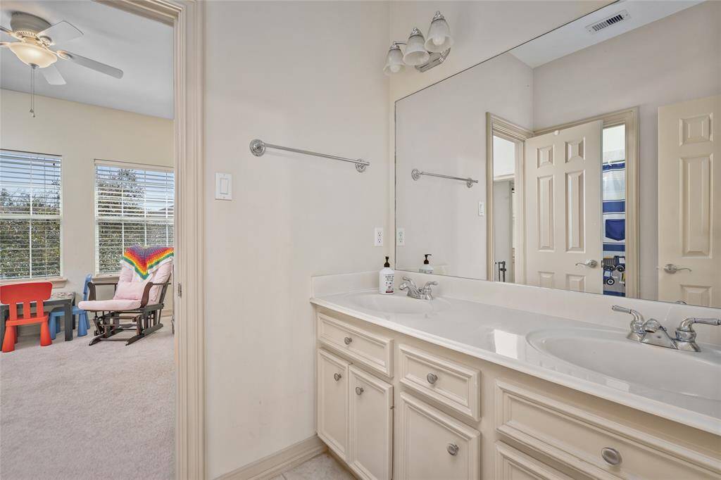 Adjoining bath features room enough for two & double sinks.