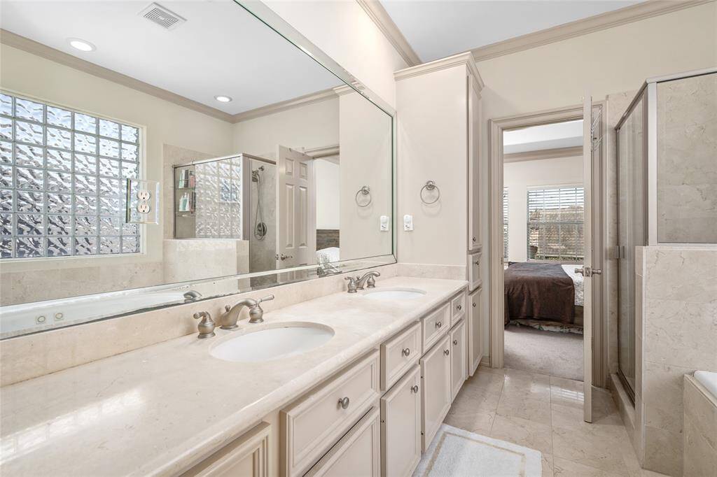 Primary bath is neutral and relaxing.  TWO large walk-in closets finish off the space.