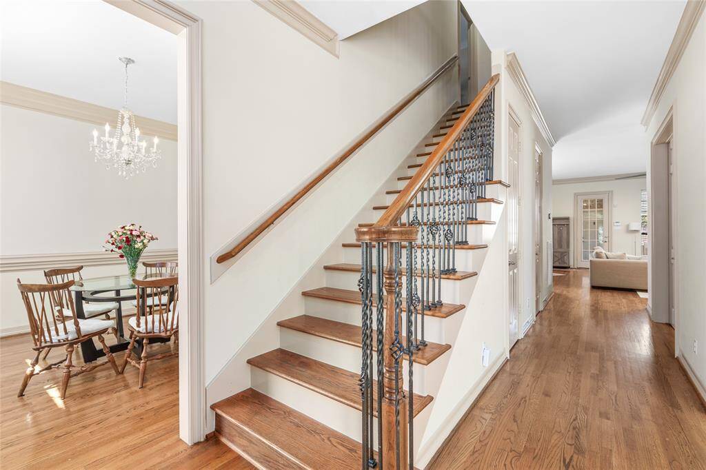 The front door is flanked by formals on either side. Note: the powder and a dedicated office off the hardwood corridor.