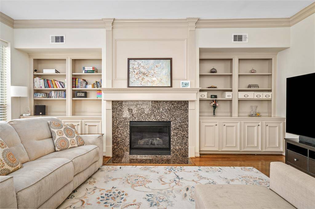 This den with fireplace is spacious and opens to the kitchen.  Its neutral tones are a perfect blank palette for your own decor.