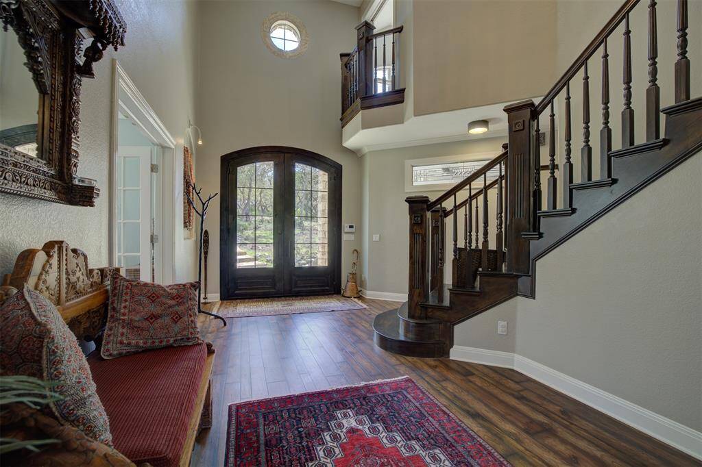 Spacious front entry. Dramatic steel doors open to a beautiful mahogany staircase.