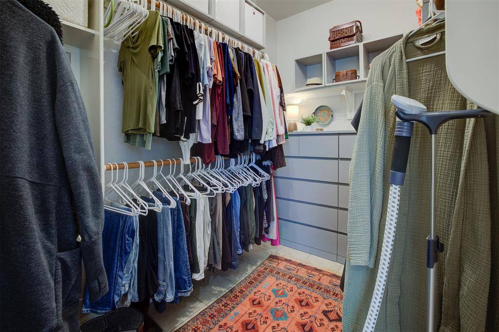 Primary bedroom closet with custom built-in cabinet.