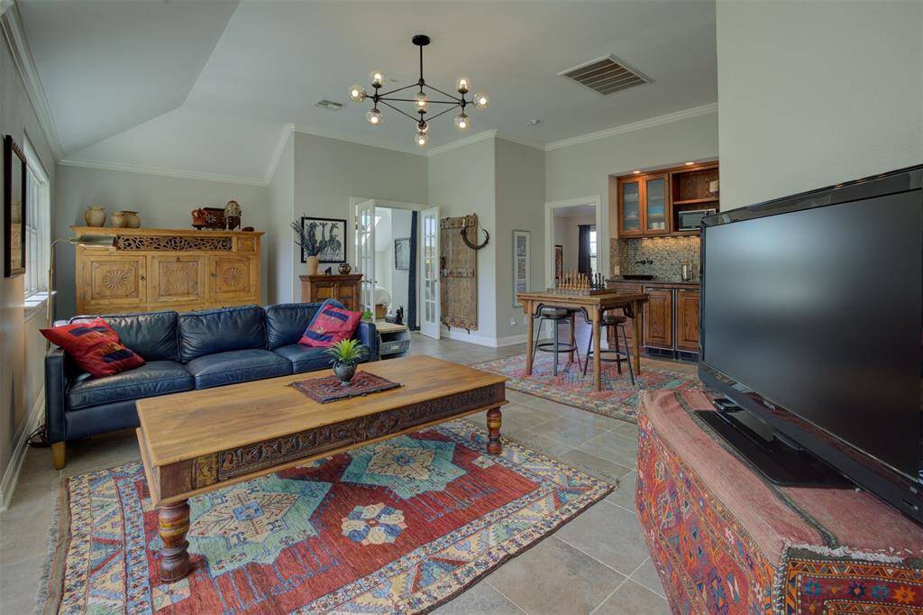 Upstairs secondary Living room with bar/sink area.