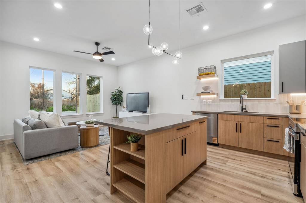Whether you're preparing a meal for guests or unwinding in the bright and airy living space, this modern and functional open-concept design ensures comfort and style at every turn.