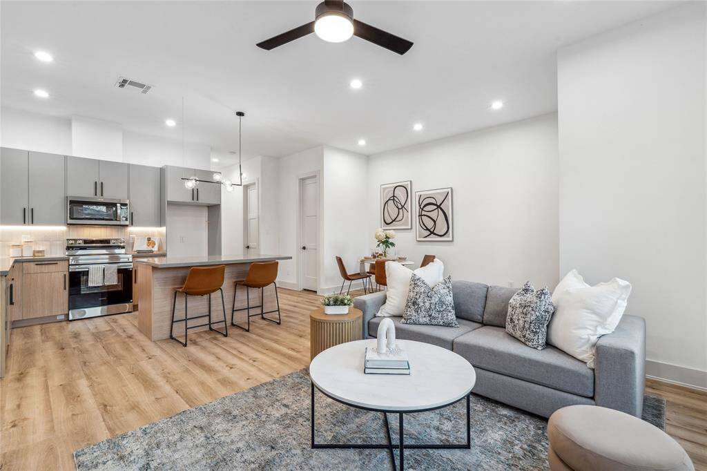 Designed for both style and functionality, this open-concept space seamlessly connects the kitchen, dining, and living areas, creating the perfect environment for entertaining and everyday comfort.