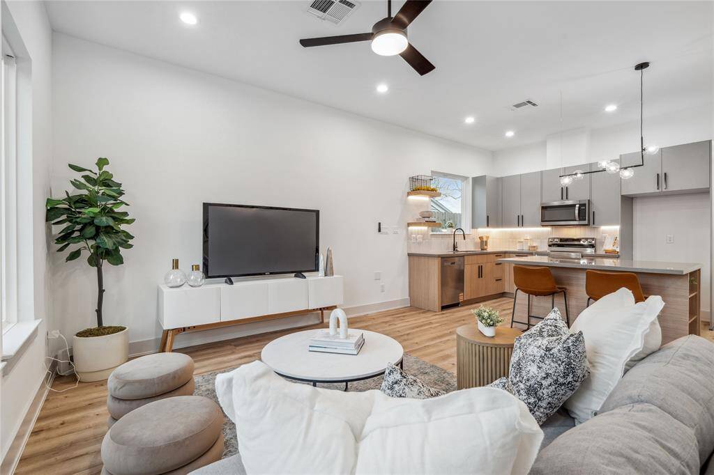 Two-toned cabinetry and under-cabinet lighting help this home feel sleek and sophisticated, enhancing the open-concept design with a perfect balance of style and warmth.