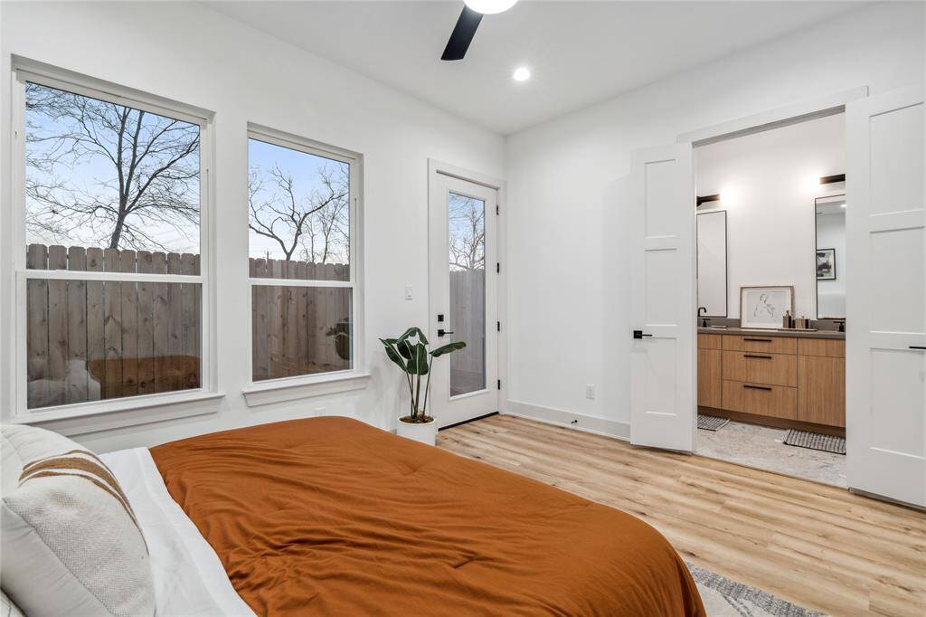 The clean lines, recessed lighting, and sleek ceiling fan enhance the modern yet cozy ambiance of the space.