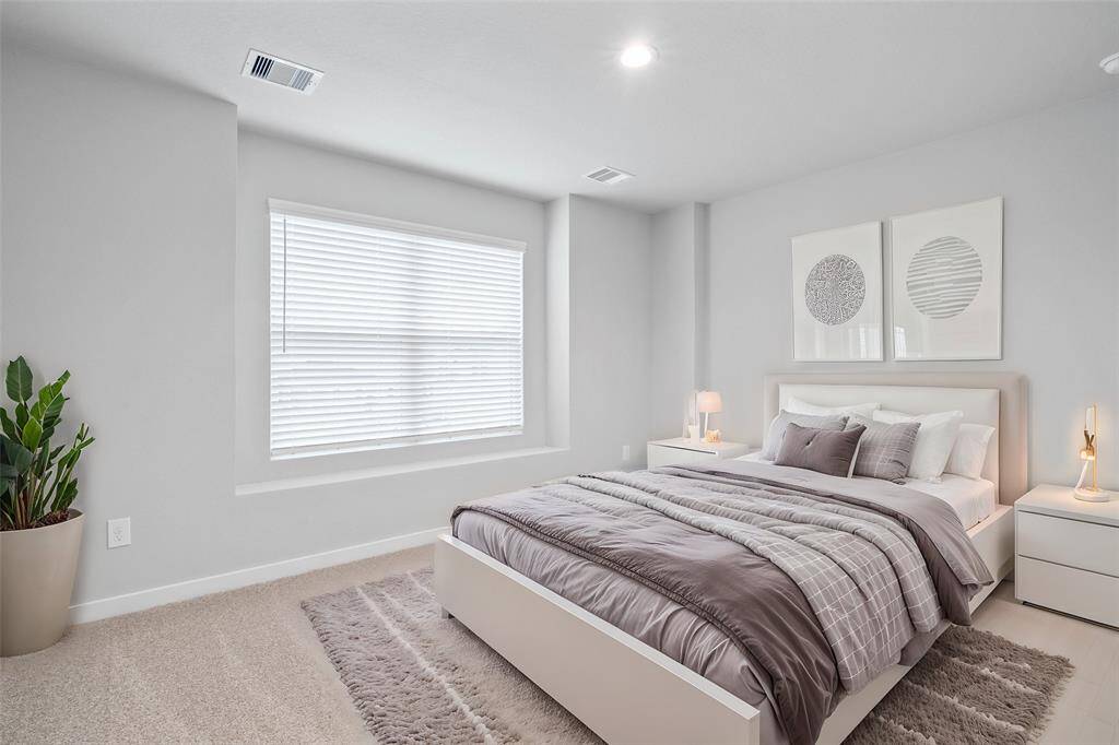 This secondary bedroom features custom paint, plush carpet, and a large window with privacy blinds!