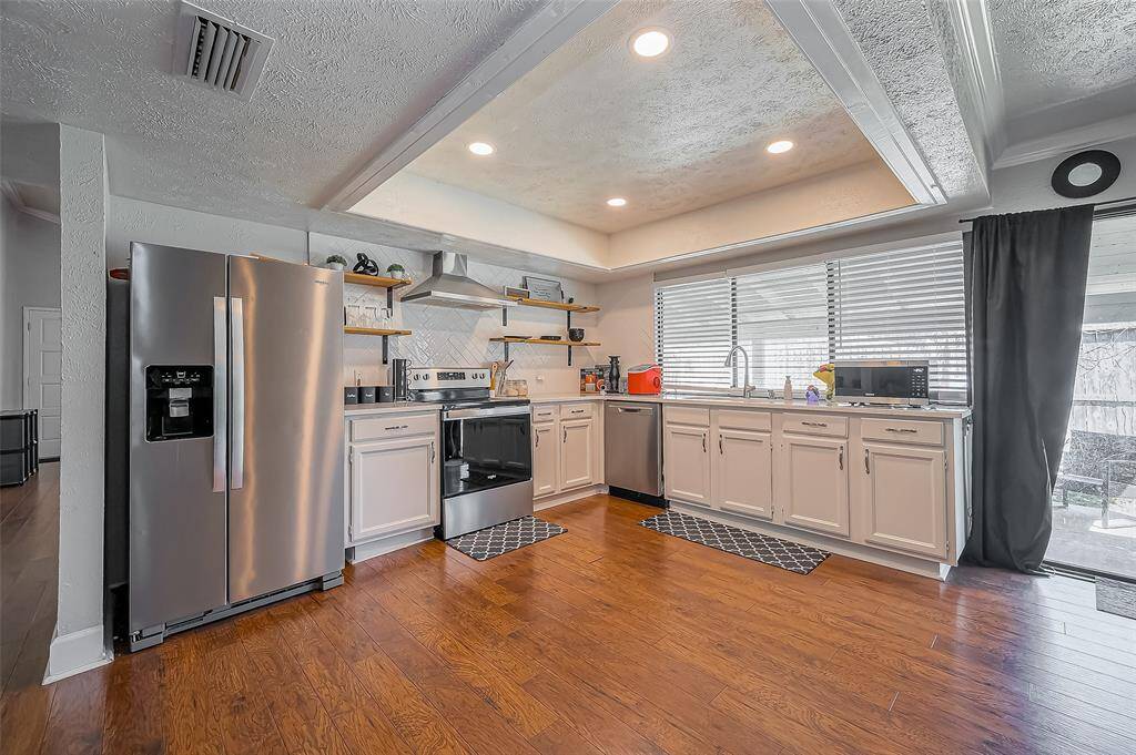 Down the hall is your beautifully updated kitchen with quartz countertops and recessed lighting. This space is also large enough to put in a kitchen island with extra seating if desired!