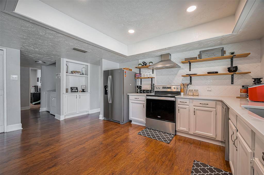 Utility room is located just off the kitchen area with newer washer/dryer