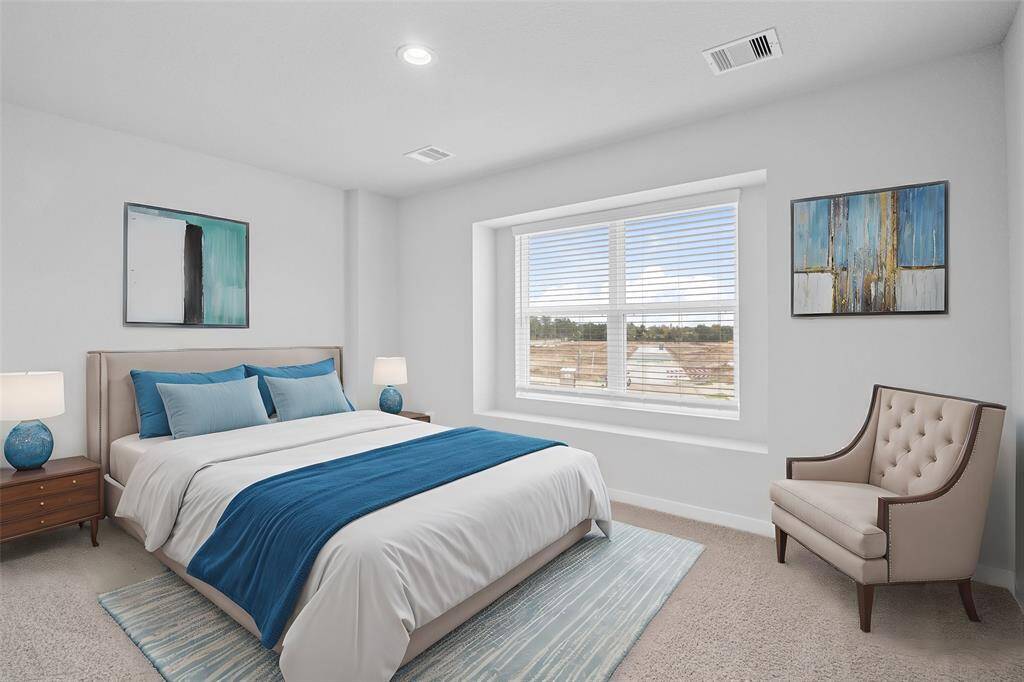 This secondary bedroom features custom paint, plush carpet, and a large window with privacy blinds!