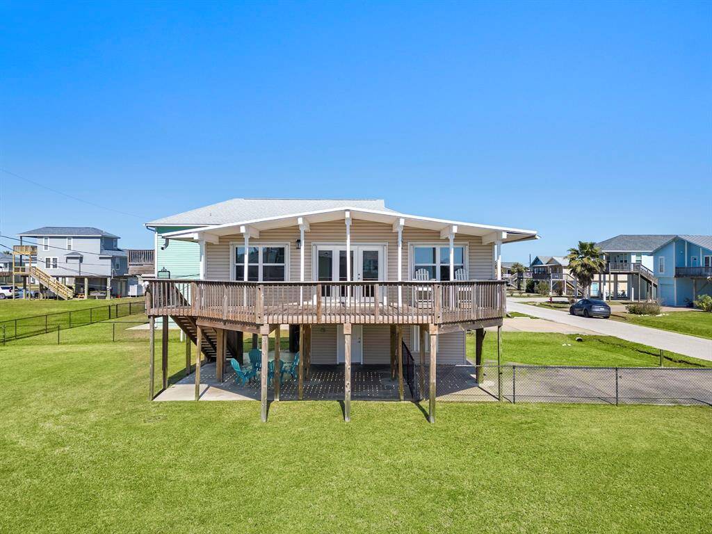 This angle highlights the driveway leading to the garage and the spacious backyard area—fully fenced and perfect for both entertaining and privacy.