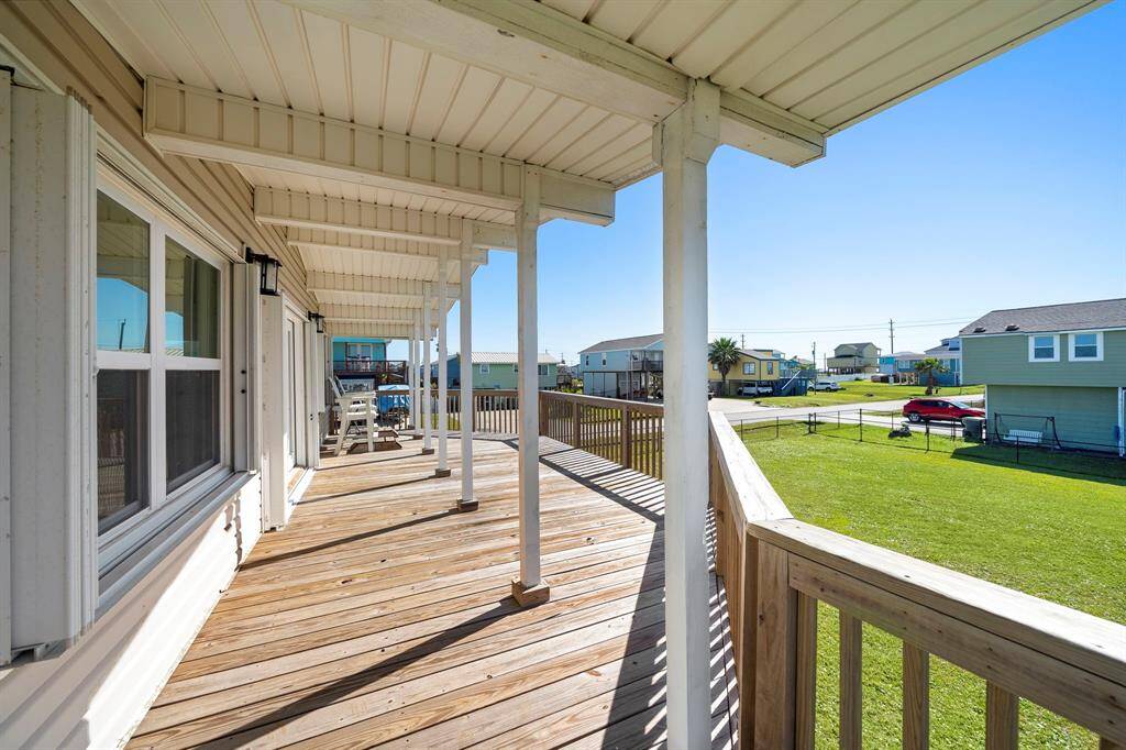 Step out onto the covered expansive deck, perfect for enjoying the coastal breeze and taking in views of the surrounding neighborhood