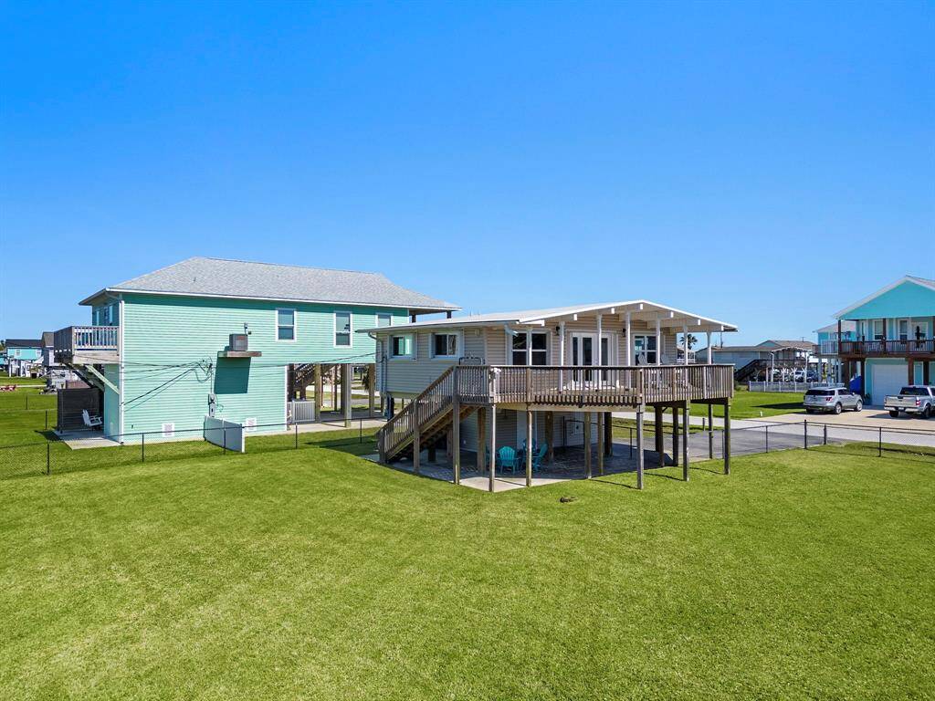 This wide open ground-level area under the home provides both practical functionality and potential for an outdoor entertaining setup.