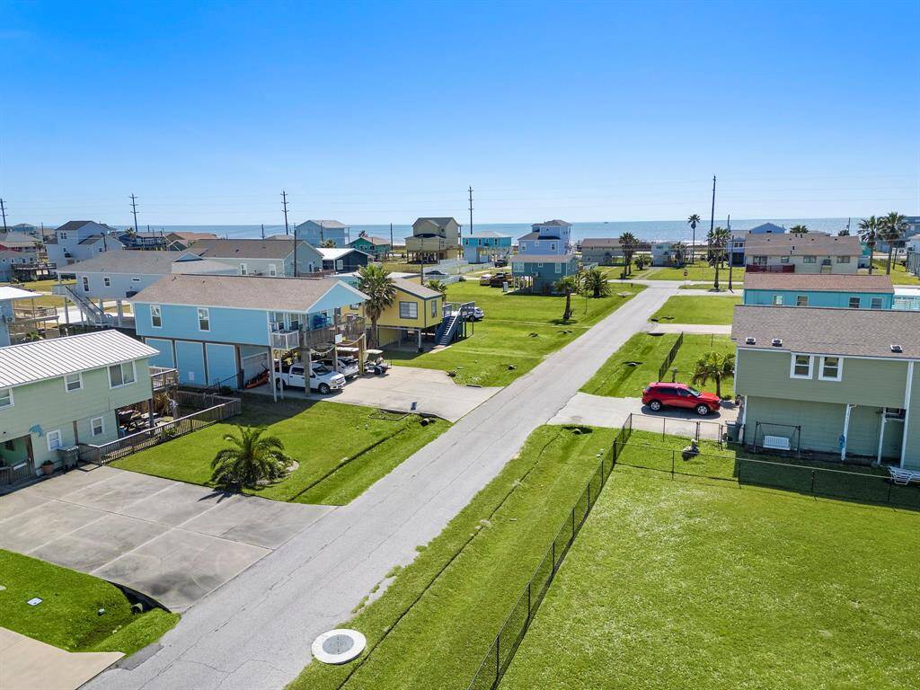 Below the home, the covered patio area offers plenty of shade and room for gathering, storage, or simply relaxing after a day at the beach.
