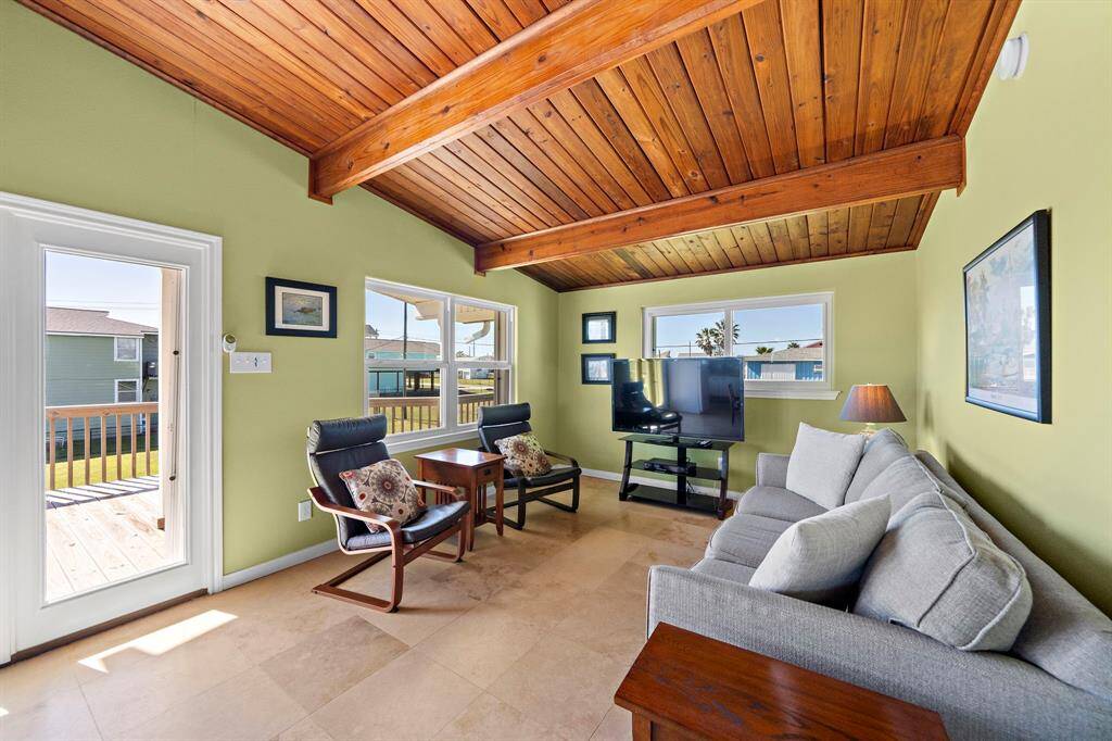 Framed by rich wood finishes and fresh green walls, this space is bathed in sunlight and offers great views through large windows.