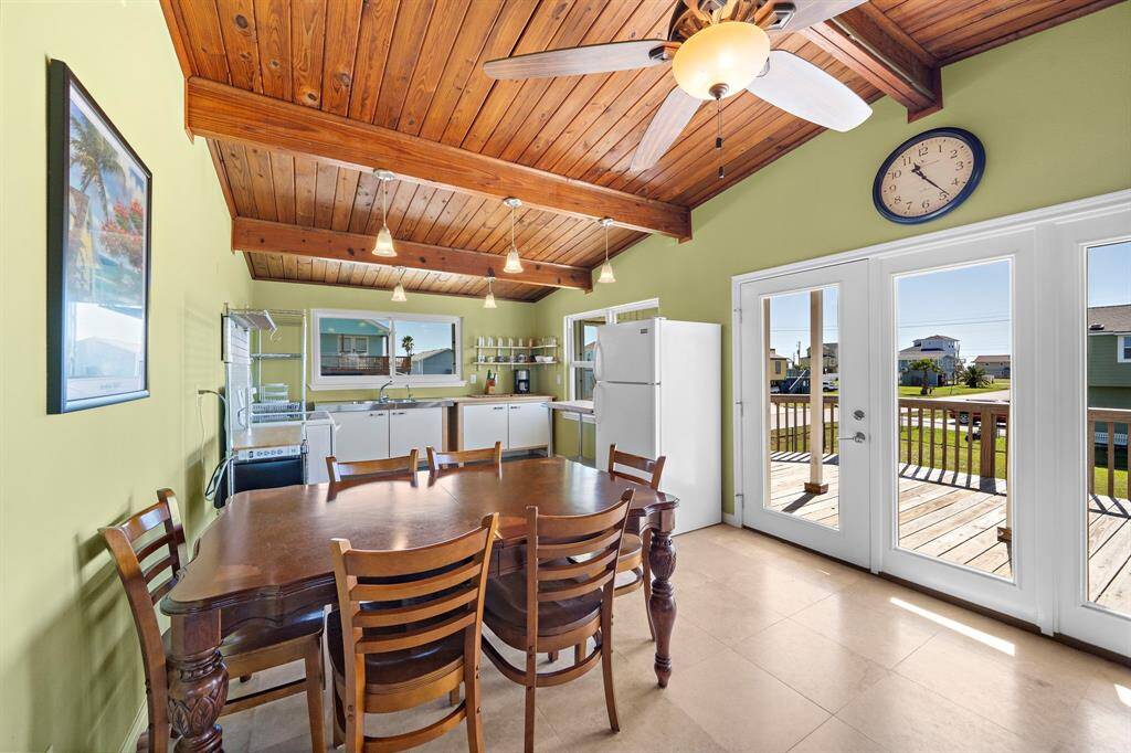 A spacious dining area sits just off the kitchen, with French doors that lead to the covered front deck. Whether hosting dinner or enjoying a sunny breakfast, this setup blends indoor comfort with outdoor charm.