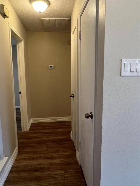 to the left is hallway to bedrooms passing two storage closets.
