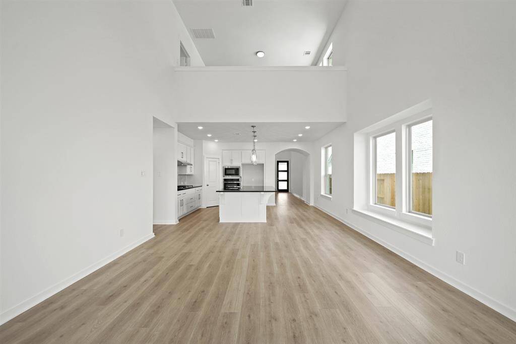 A beautiful white and black contrast color kitchen invites you to prepare amazing meals