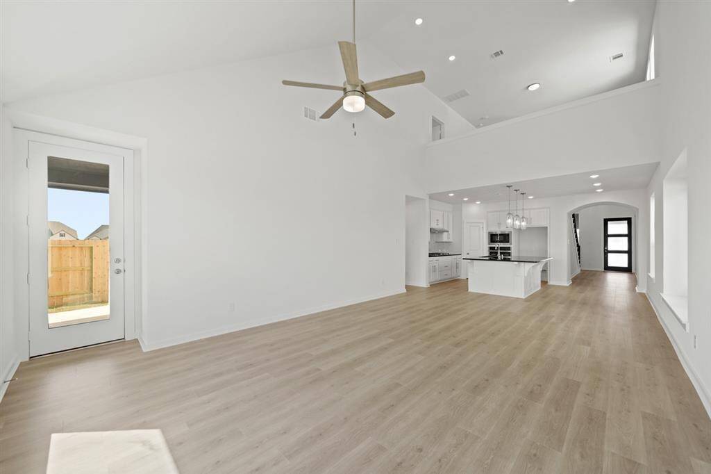 The open-concept family room allows easy flow into dining and kitchen areas for effortless daily living or hosting gatherings with family and friends.