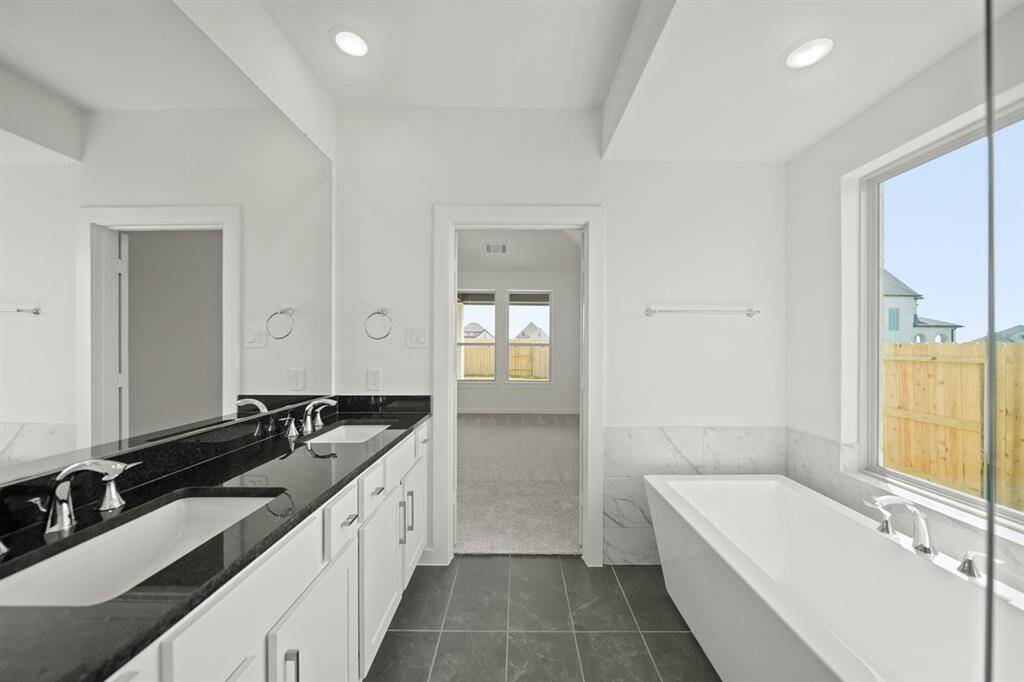 The open-concept family room allows easy flow into dining and kitchen areas for effortless daily living or hosting gatherings with family and friends.