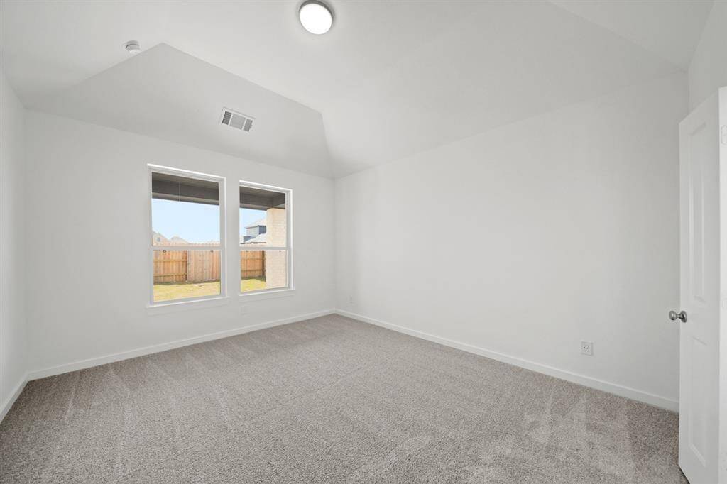 The spacious primary bedroom provides a comfortable place to unwind