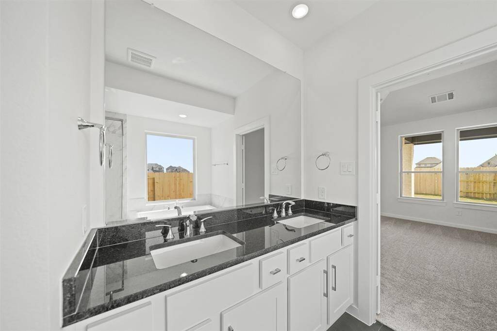 The spacious primary bedroom provides a comfortable place to unwind
