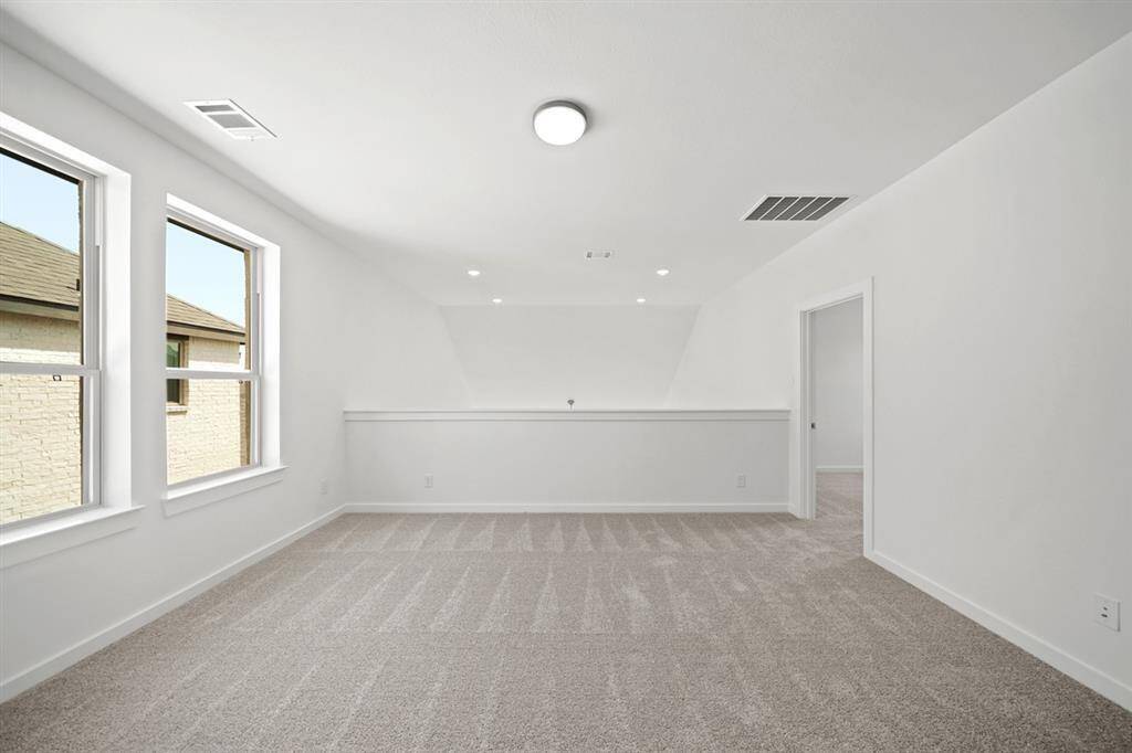 A large game room provides an inviting atmosphere with plenty of space and natural sunlight