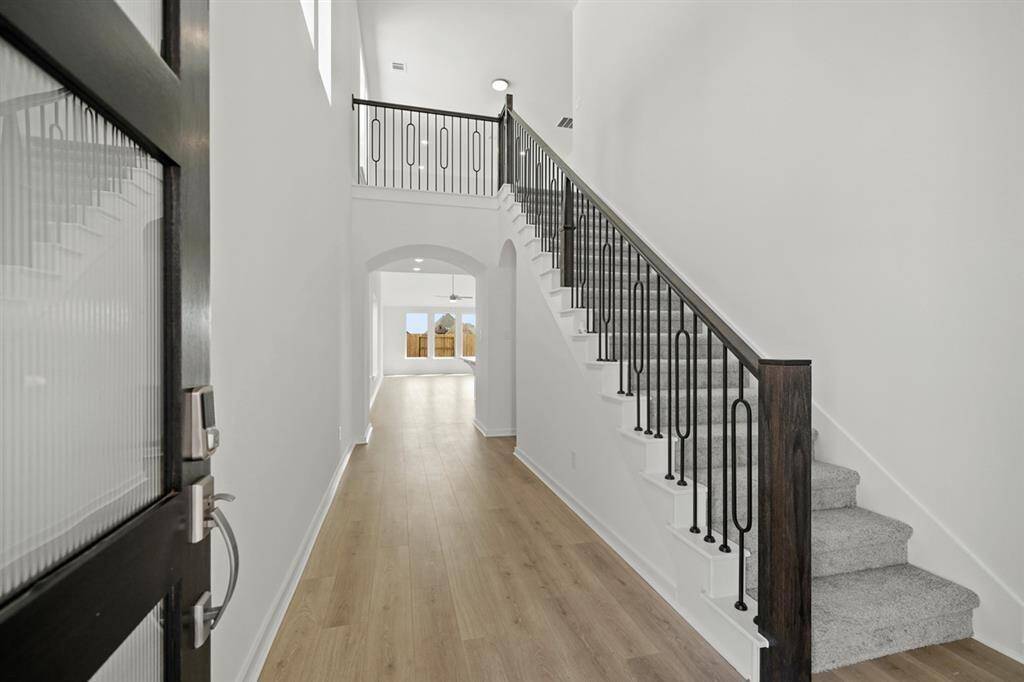 Soaring 20ft ceilings in grand entryway welcome guests with dramatic and unforgettable first impression.