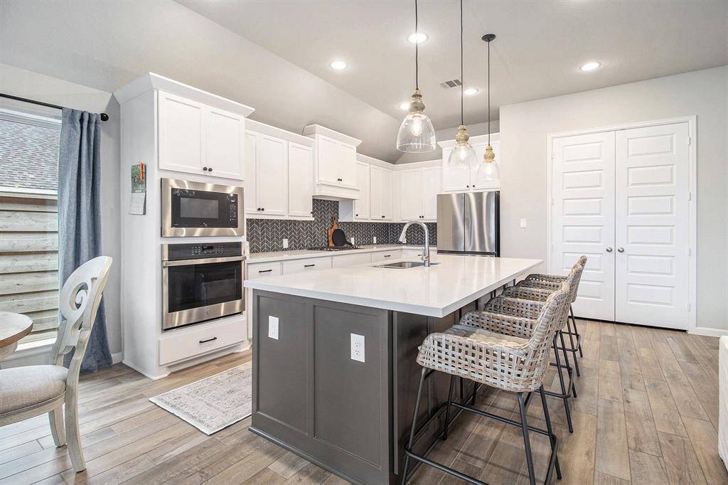 open area to living room with beautiful long windows