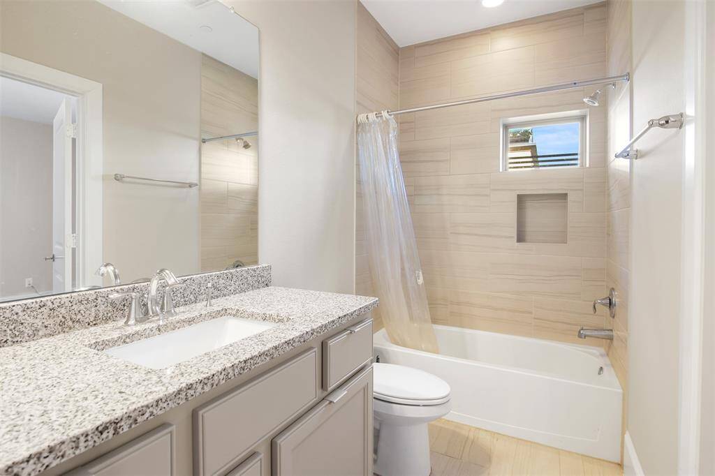 Secondary en suite, full bathroom located on the first floor.  It has beautiful tile surround around the tub/shower combo, gorgeous countertops, and more storage space.