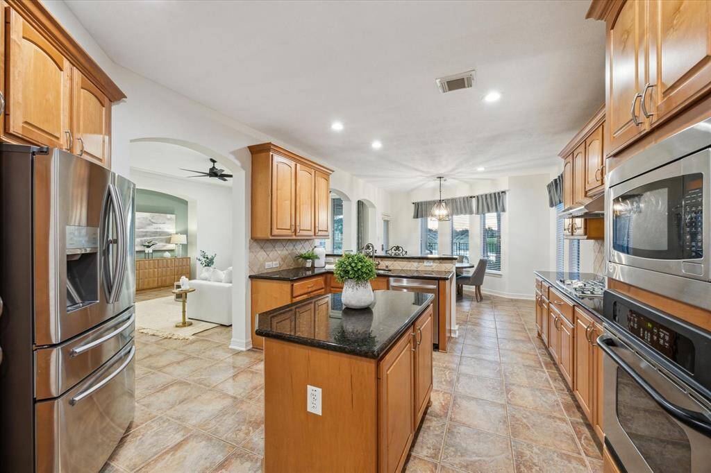 The kitchen opens seamlessly into the spacious family room, creating an inviting flow for gatherings. Whether preparing meals or enjoying company.