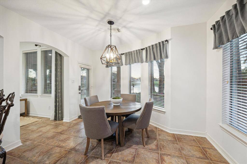 The sunny breakfast area is bathed in natural light and offers fantastic lake views. Step through the patio door and onto the patio.