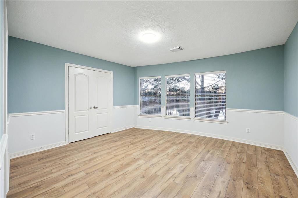 This spacious secondary bedroom offers plenty of room for comfort and relaxation.