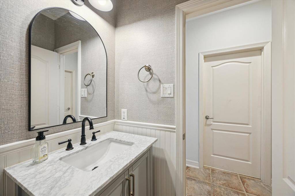 Conveniently located off the entry, the powder room offers easy access for family and guests, adjacent to the functional mudroom.