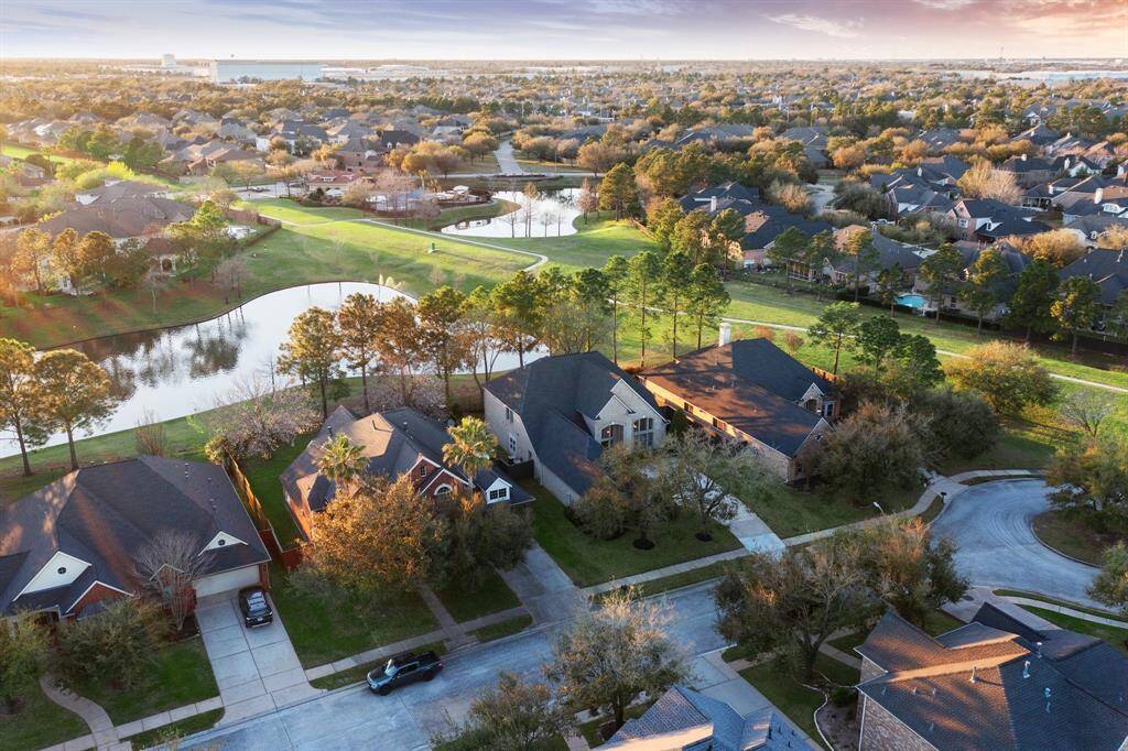 Surrounded by lush greenery and serene lake views, this bird's-eye perspective highlights the spacious layout and close proximity to neighborhood amenities.