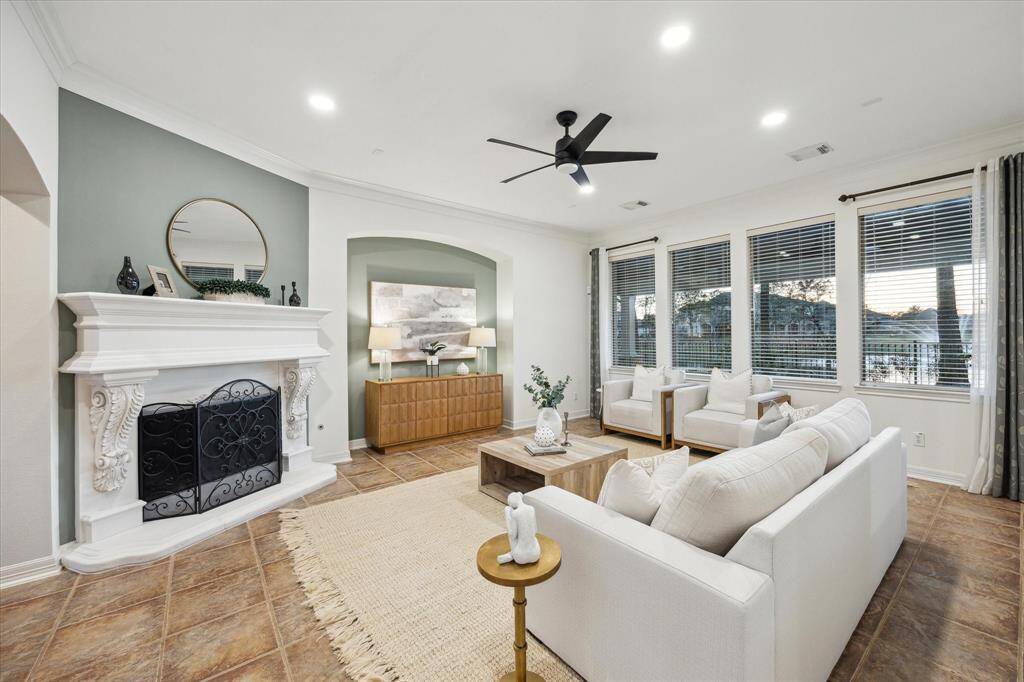 Family room features a cast stone fireplace that serves as the room’s focal point.