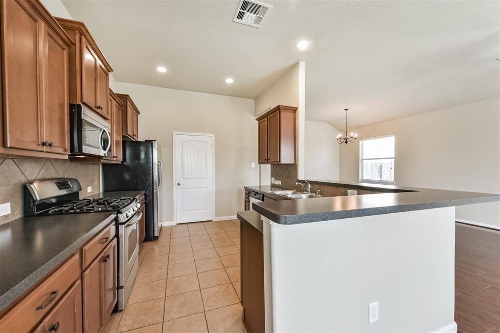 Sleek kitchen with stainless steel appliances and generous counter space.