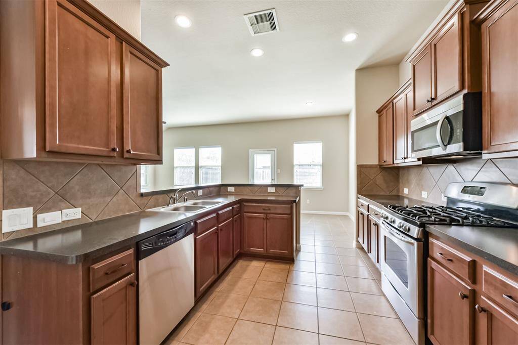 Recess lights in kitchen and tile floors.