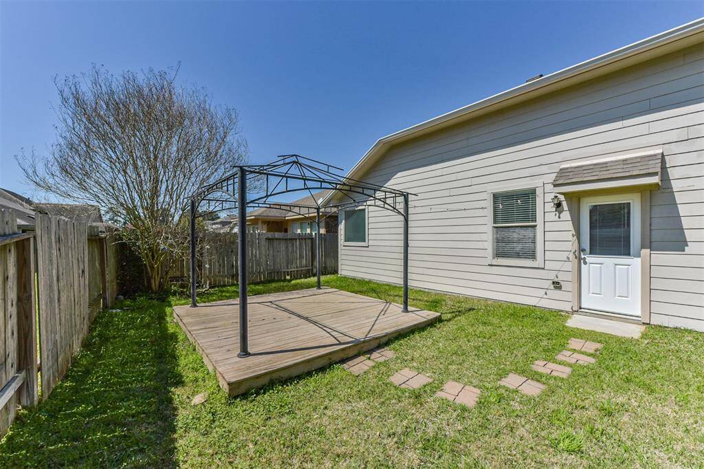 The wooden deck with metal frame is ideal for outdoor relaxation.  Perfect for a simple garden setup or entertaining guests.