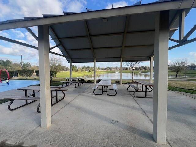 Charming picnic area with covered seating and serene lakeside views, perfect for outdoor gatherings.