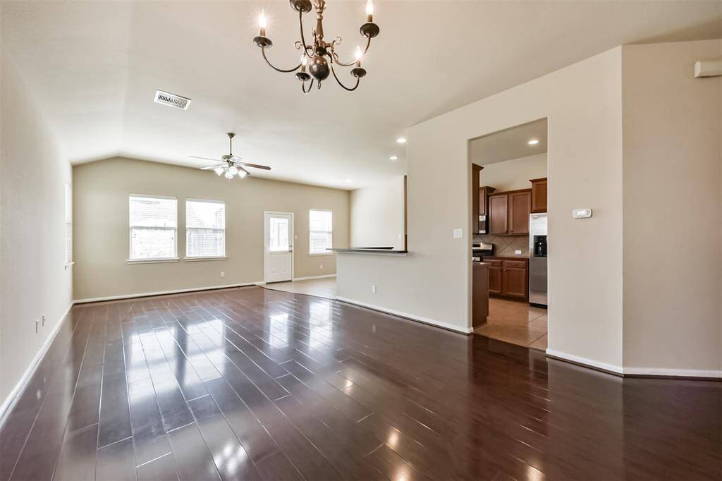 Spacious family room seamlessly connects to the kitchen, perfect for all your family gatherings.