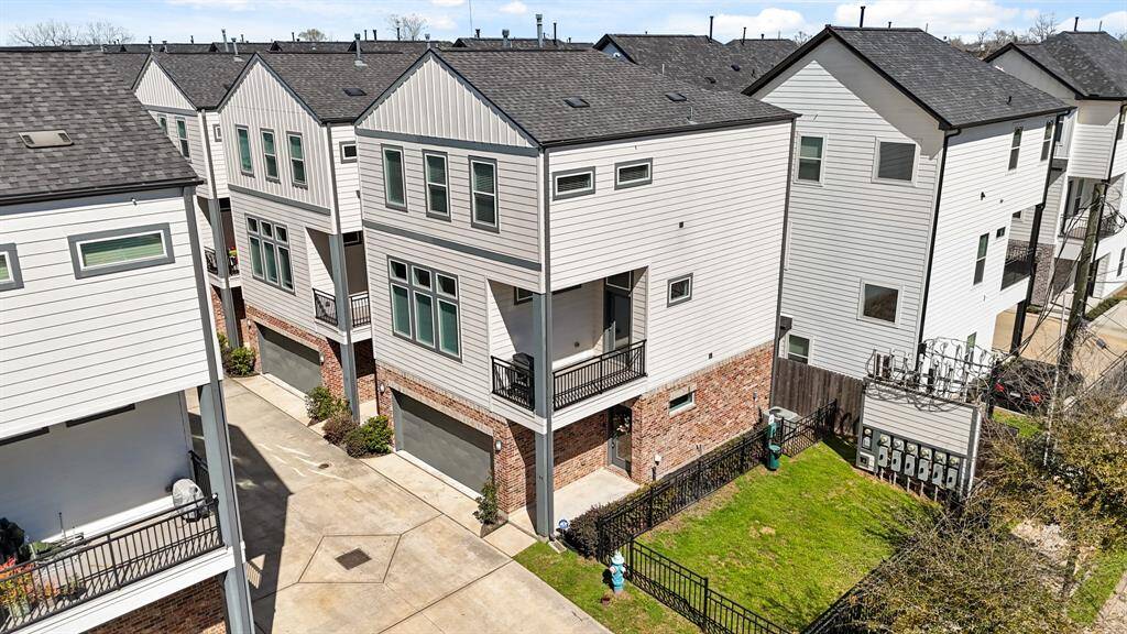 Situated in a gated community within minutes of Interstate 610, Downtown Houston and popular shopping & dining destinations, sits this beautiful freestanding home featuring a cement board exterior with brick accents, a wrought iron balcony from the second floor patio & professional landscaping.