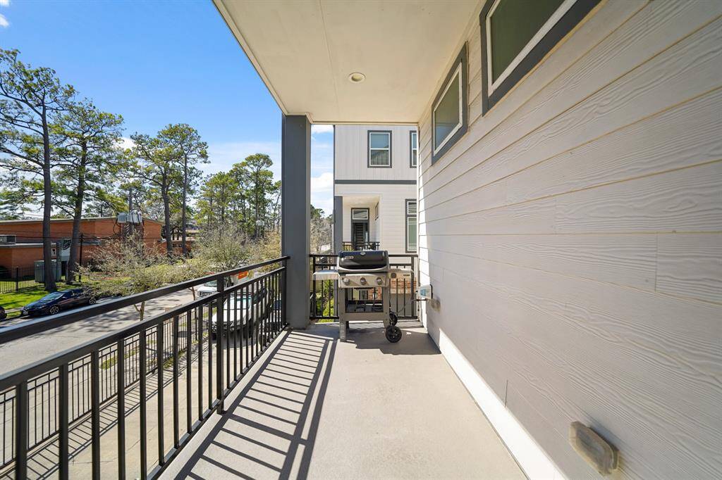 Just off the living area, a glass door with blinds and transom above offers access to a covered patio.