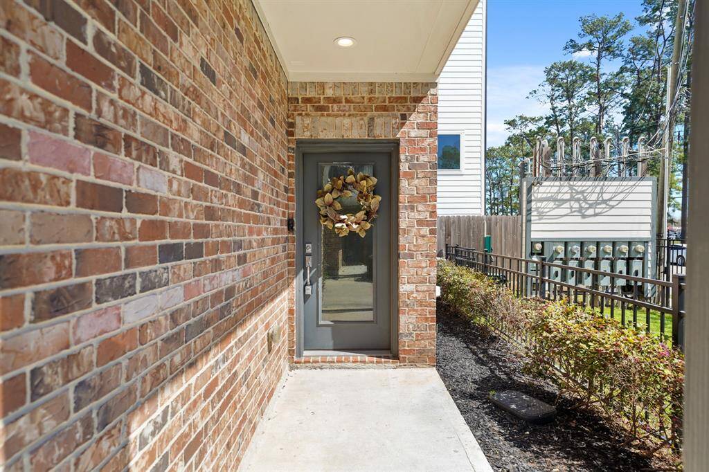 The charming covered front porch overlooks the community dog park and includes recessed lighting and a video door bell. A walkway leads to the double-wide driveway flanked by wall mounted lighting and the garage with space for two cars includes an automatic garage door opener.